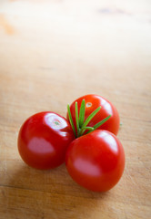 tomatoes on brown textured wood