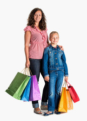 Smiling mother and daughter with shopping bags