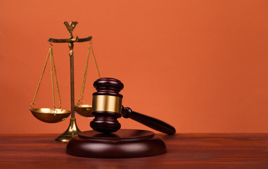 judge gavel and scales of justice on table