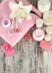 Beautiful spa setting with lily on wooden table close-up