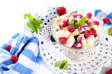 Fruit salad in glass bowl, isolated on white