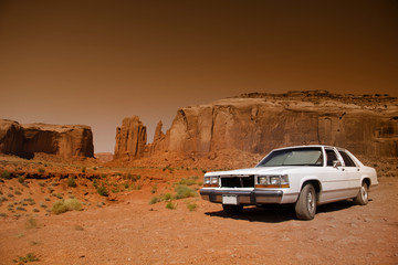 Classic car in the desert of Monument valley