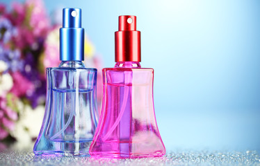 Women perfume in beautiful bottles and flowers