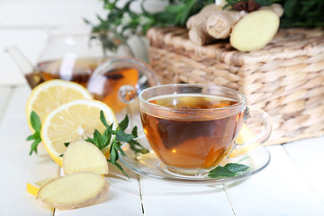 Kettle and cup of tea with ginger