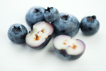 Horizontal shot of whole and halved blueberries, macro
