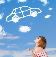 Young girl looking at car cloud on a blue sky