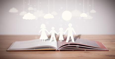 Cardboard figures of the family on opened book