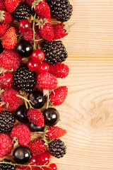 Ripe Berries on Wooden Background
