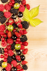 Ripe Berries on Wooden Background