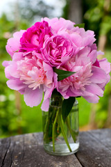 peony and rose bouquet on wooden surface