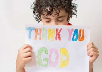 Hispanic child holding a religious sign