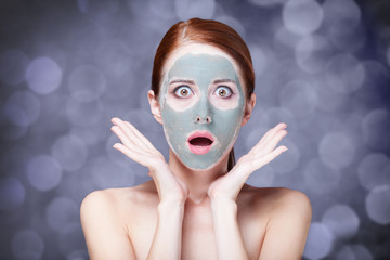 Redhead girl in cream mask