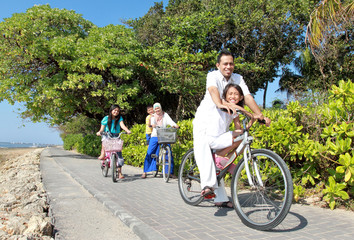 Fototapeta premium Happy asian family riding bikes in the beautiful morning at the