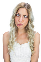 Naklejka premium Funny blonde squinting while posing