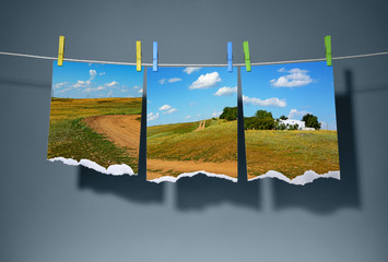 Cutting a landscape photos on clothespins. Travel concept