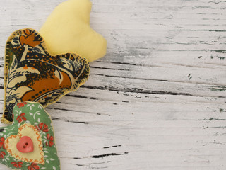 textile hearts on the wooden background