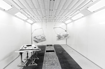 Car doors hanging inside a car paint box
