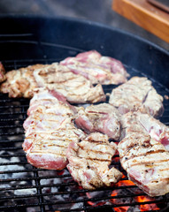 Raw steaks on a grill