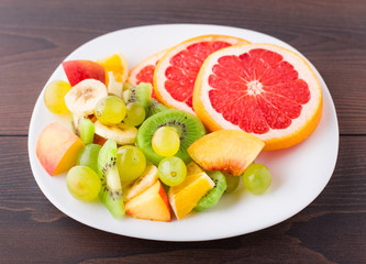 Assortment of sliced fruits on plate