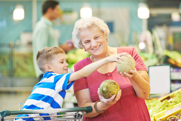 Adult woman with child shopping fruits