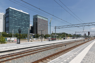 Fototapeta premium Railway station with office buildings in Amsterdam