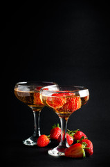 Two glasses of cold champagne with strawberries
