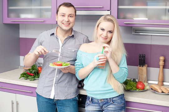 Portrait of a cute young couple preparing eating healthy snack