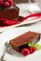 Chocolate loaf cake with chocolate frosting and raspberry