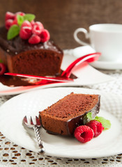 Fototapeta na wymiar Chocolate loaf cake with chocolate frosting and raspberry