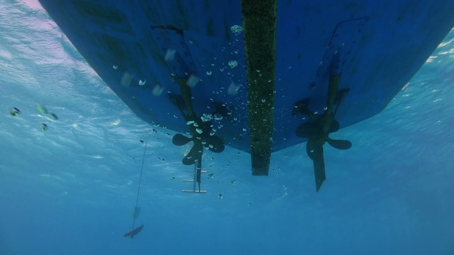 View of the propeller from the bottom of the ship under water