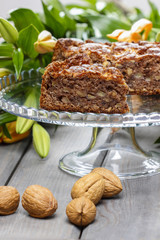 Pieces of nut cake on wooden table.
