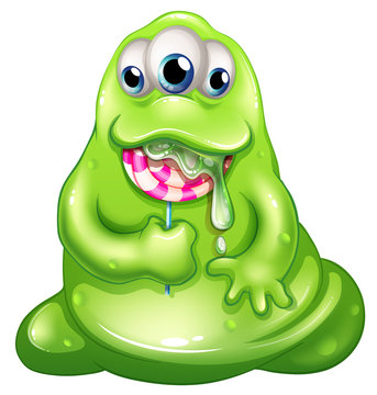 A greenslime baby monster eating a lollipop