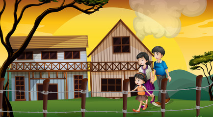 A family walking in front of the wooden houses