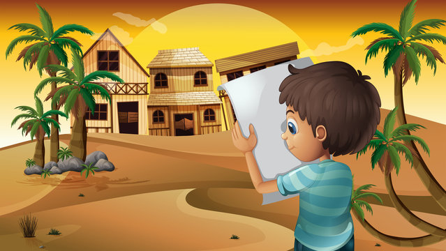 A boy holding an empty paper at the desert