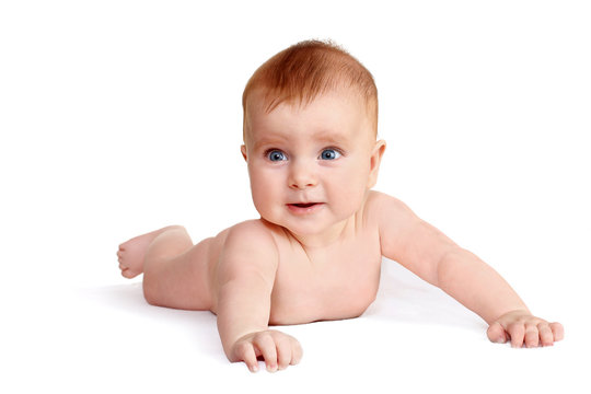 cute baby lies on his tummy and looks forward. naked child. 