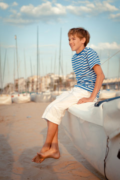 Portrait of young sailor near yacht