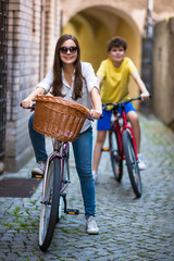 Urban biking - teens riding bikes in city