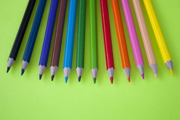 Colored pencils on a green background