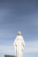 virgin mary against a blue sky