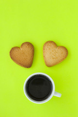 Cup of coffee and cookies in the form of heart.