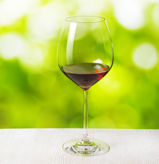 Glass of wine on nature background