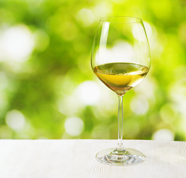 Glass of wine on nature background