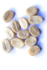 green and roasted coffee beans on white background