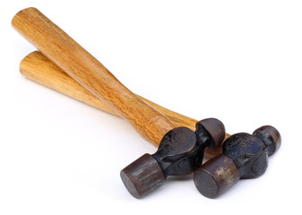 Two hammers over white background
