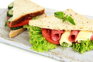 Tasty sandwiches with salami sausage and vegetables