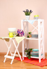 Beautiful white furniture with tableware and decor,