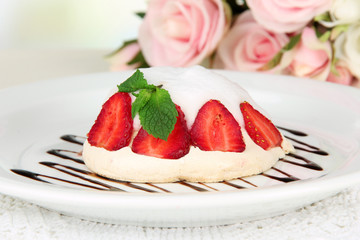 Tasty meringue cake with berries on table