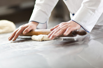 Chef prepairing dough in the kitchen