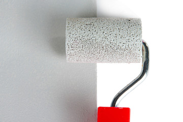 Roller brush with grey paint closeup