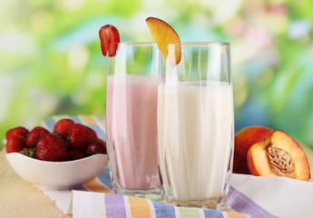 Delicious milk shakes with strawberries and peach